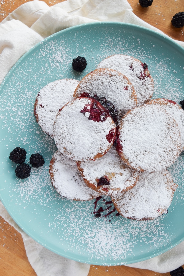 Above shot of a pile of freshly baked black raspberry jelly doughnuts.
