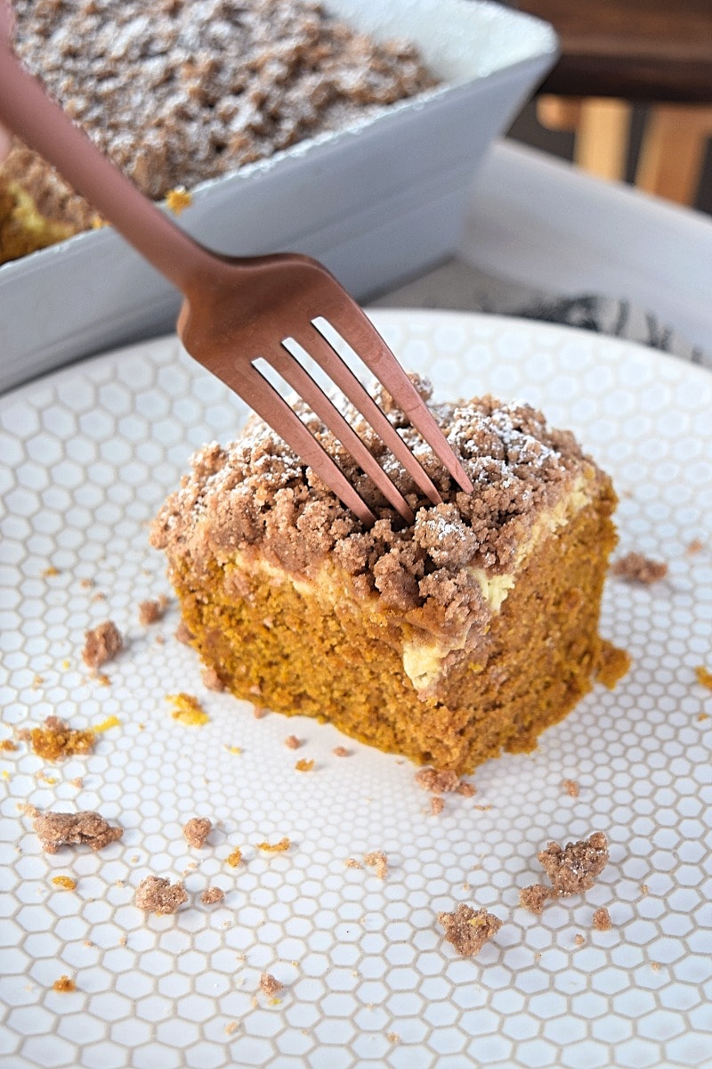 Poking a fork into a piece of pumpkin coffee cake