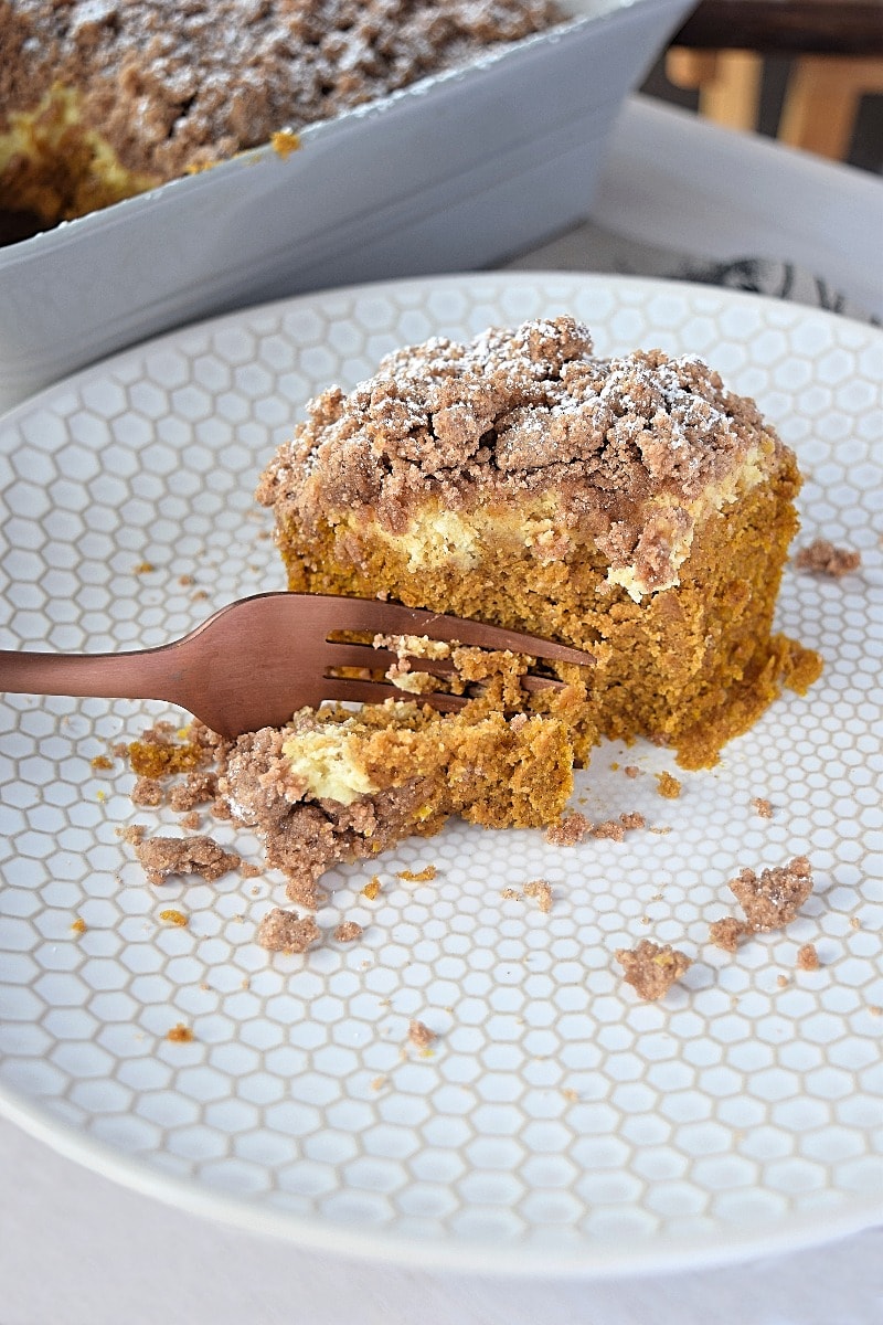 Cutting a piece of gluten free pumpkin coffee cake with a fork