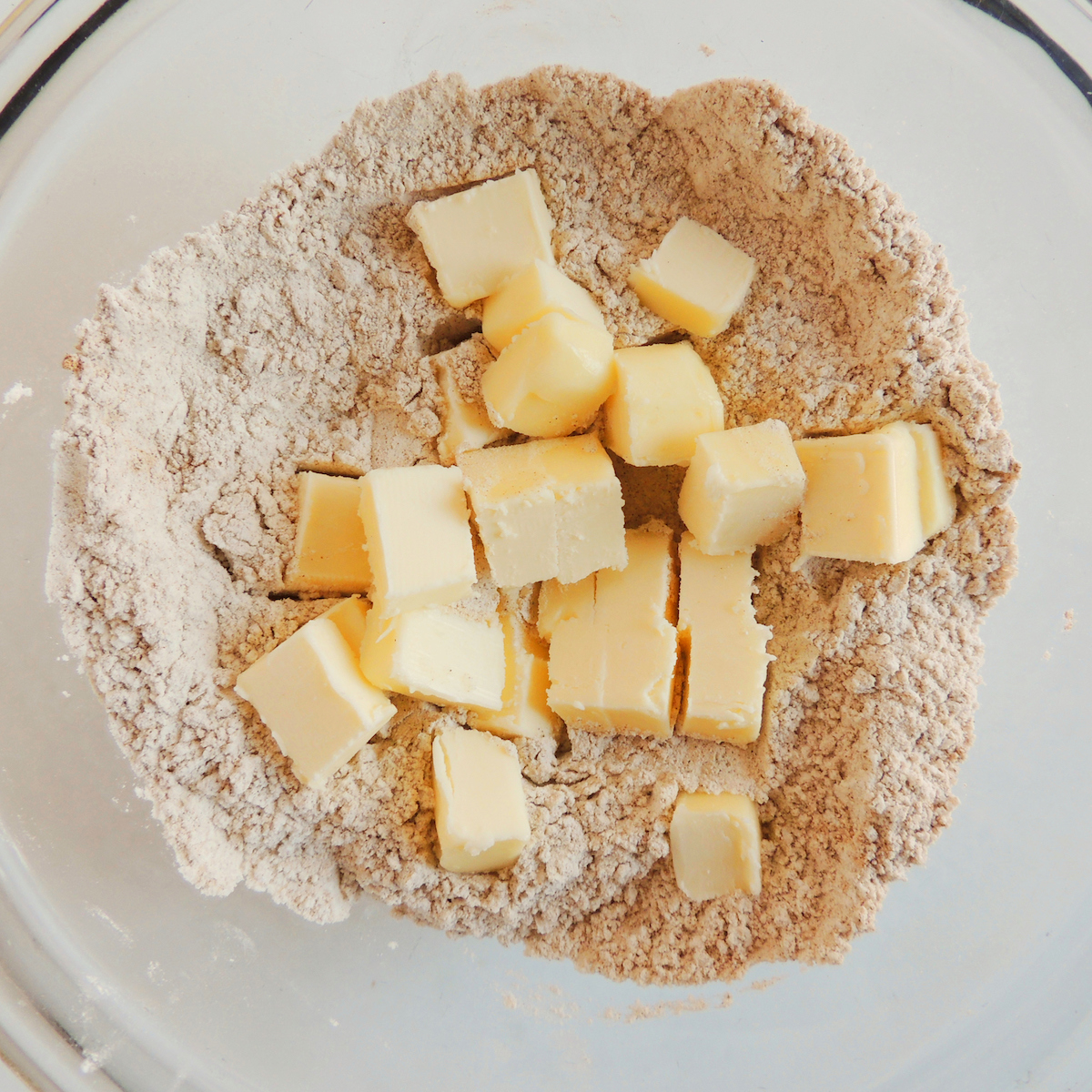 Adding butter to the flour mixture for gluten free pumpkin scones.