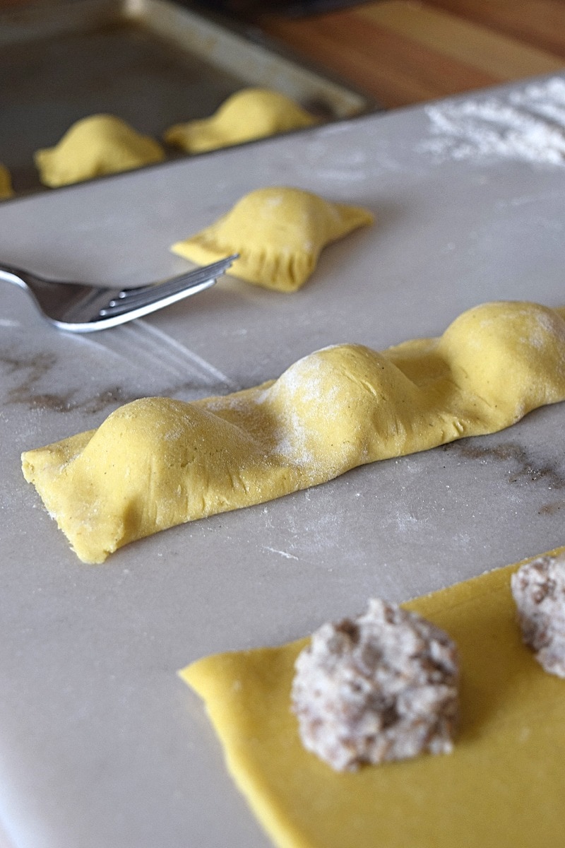 Uncooked ravioli being made