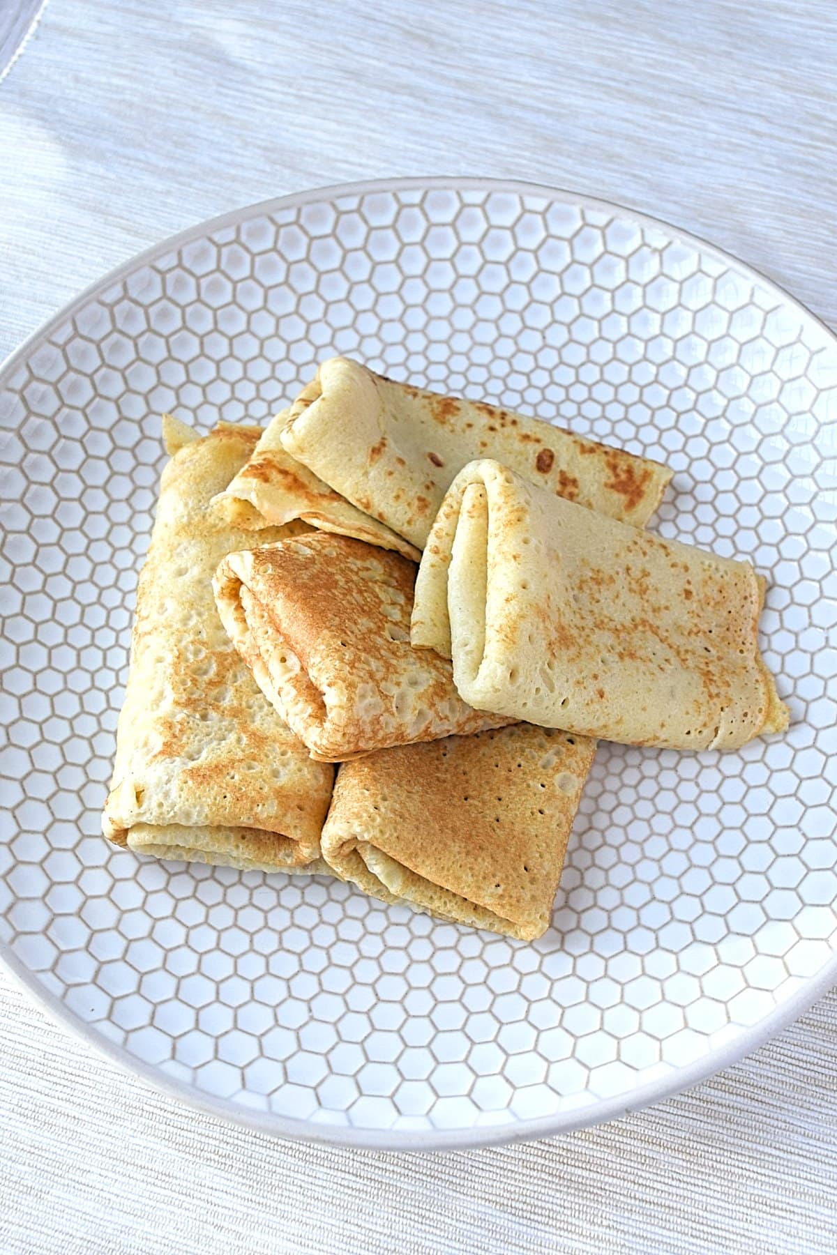 Image of a plate filled with gluten free crepes.