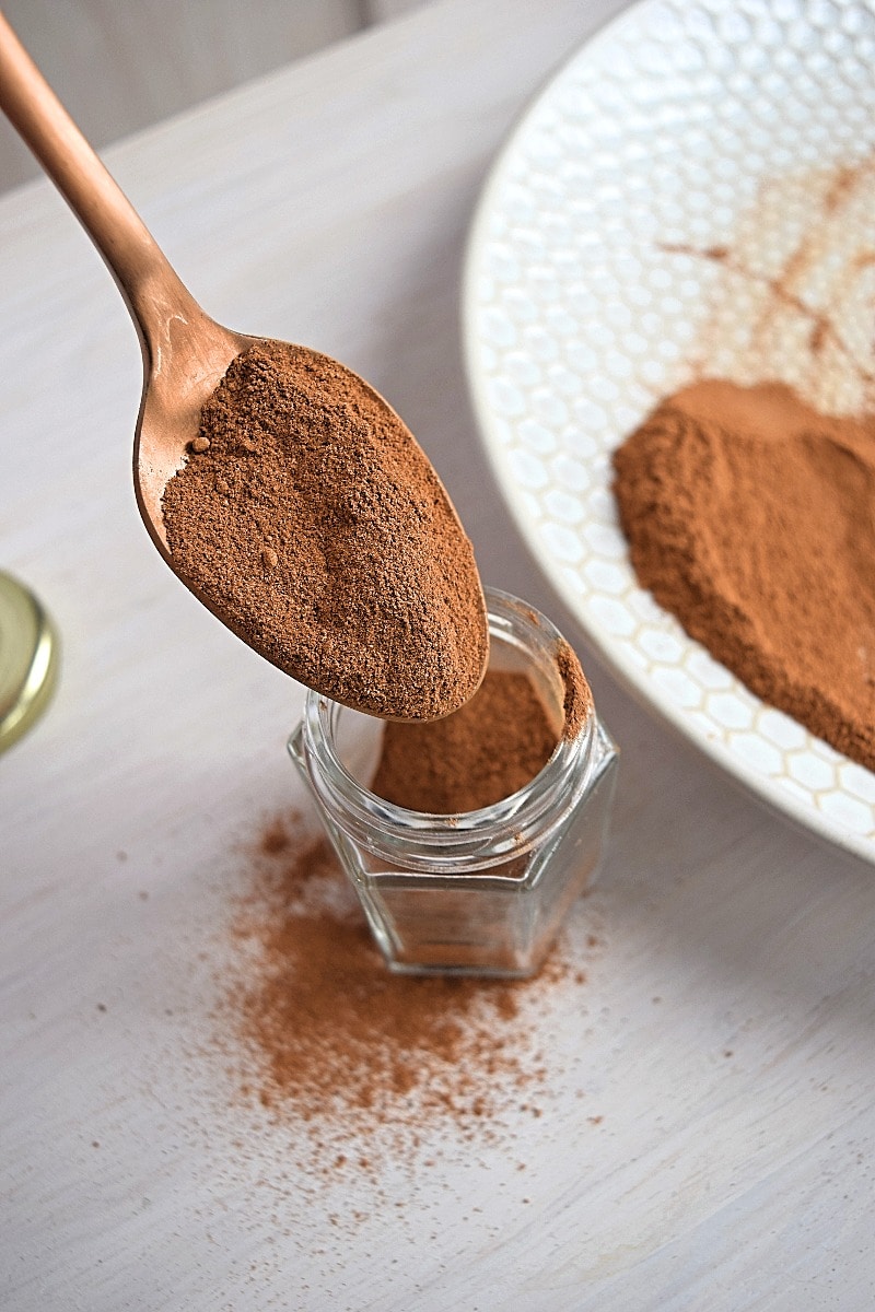 A spoonful of freshly made pumpkin spice being put into the jar