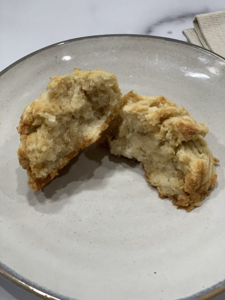 gluten free scone split in half and displayed on an earthenware plate