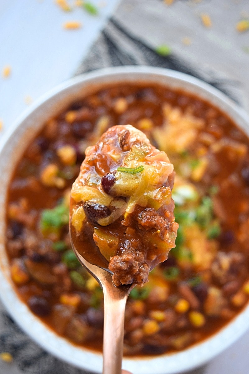 Spoonful of chili held above the bowl