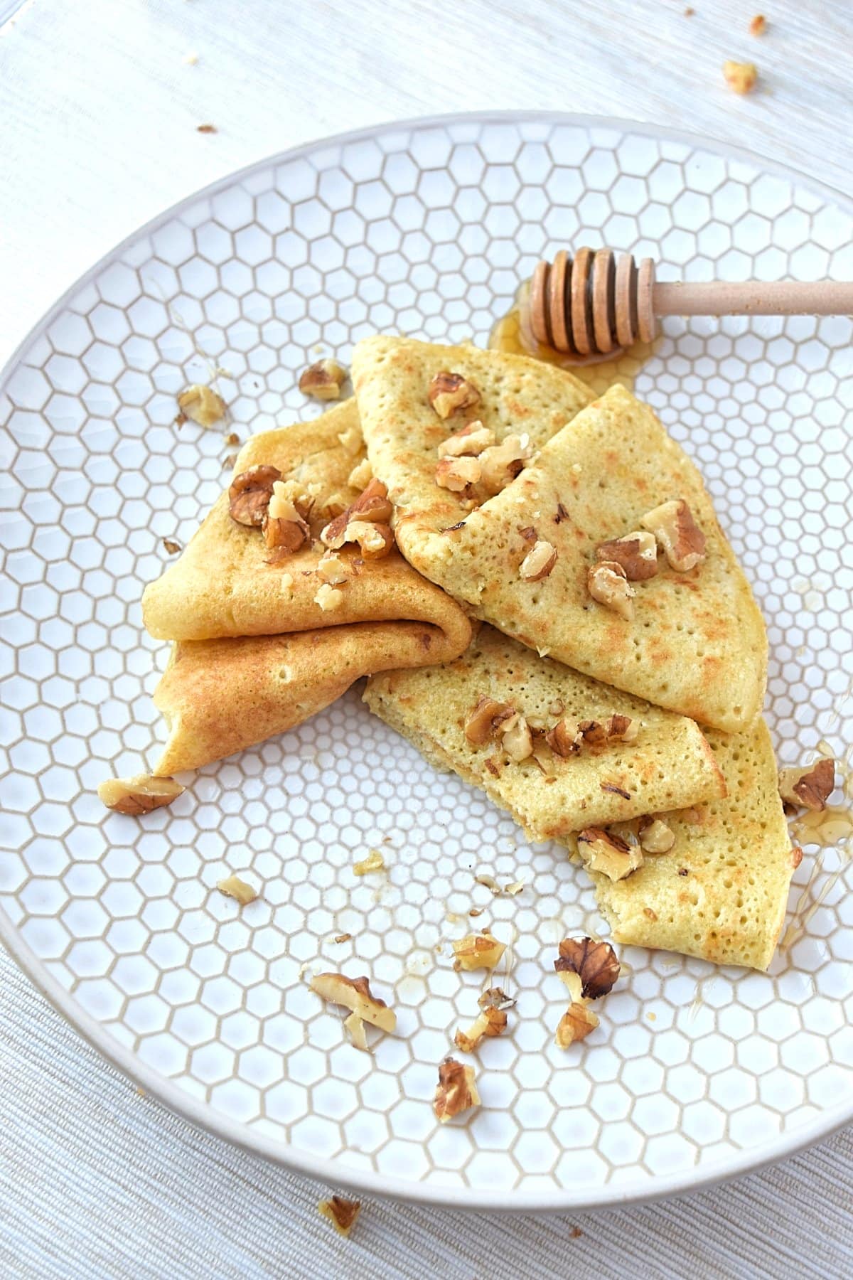 Plate of paleo crepes with a bite taken out of it