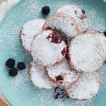 Above shot of a pile of freshly baked black raspberry jelly doughnuts.