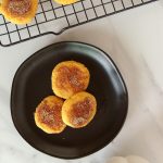 Cover image for gluten free keto pumpkin cookies - overhead view of 3 cookies on a black plate.