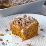 Cover image for pumpkin coffee cake post. Features a single piece of cake sitting in the middle of a white plate.