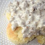 Cover image for Gluten Free Biscuits and Gravy. Features gluten free buttermilk biscuits with gravy on them.